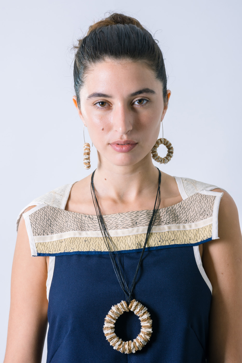 Close up of a eautiful woman portrait with rounded necklace and